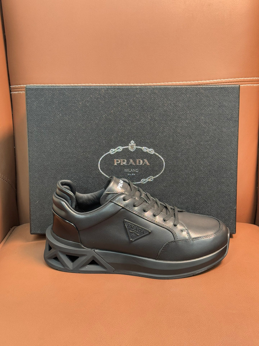 Prada dark leather lace-up sneaker with sculpted sole and logo detail
