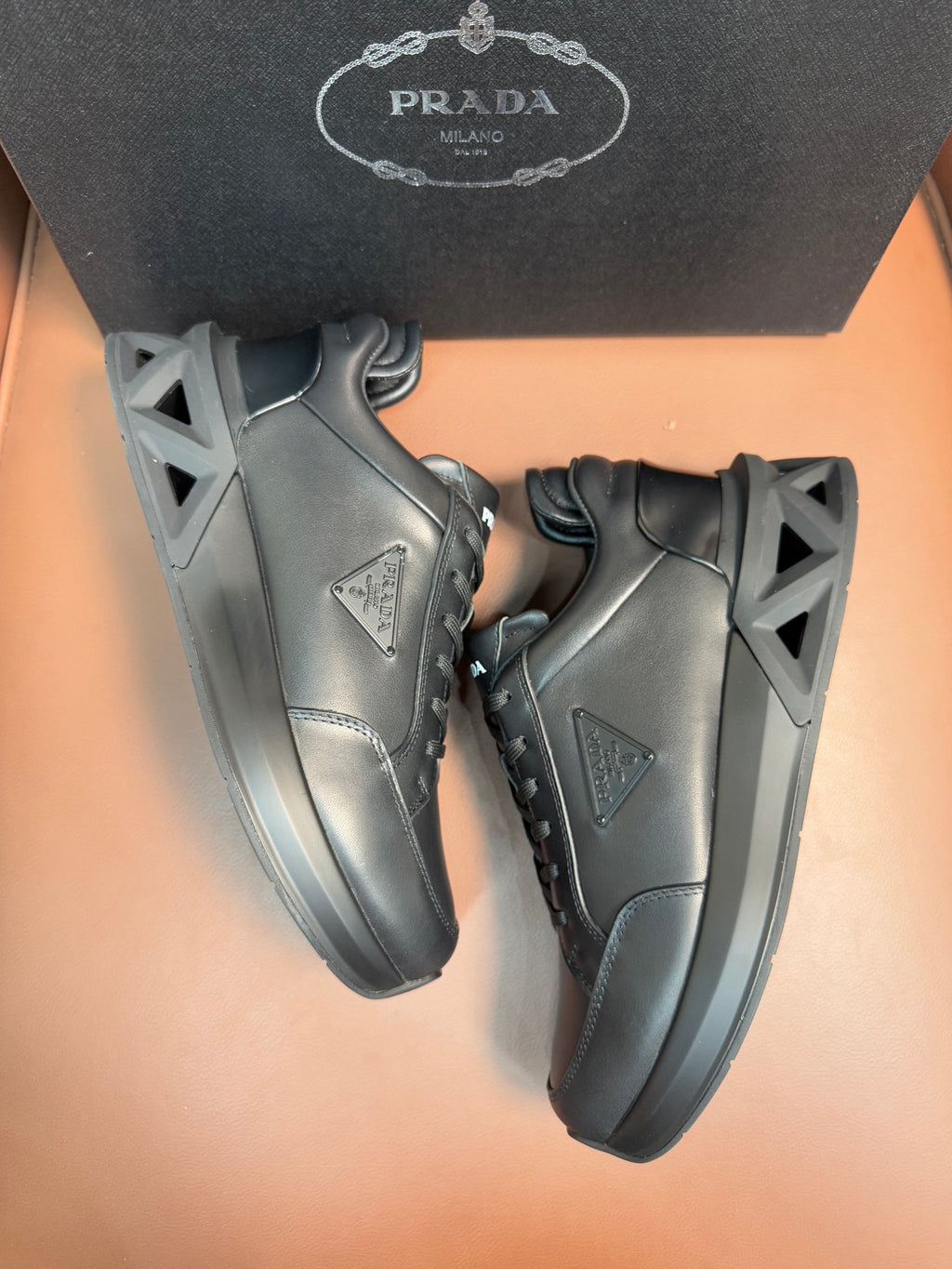Prada dark leather sneakers, side logo triangle and lace-up design