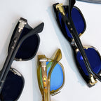 Chrome glasses with dark, gold, and blue lenses in metal frames, close-up