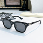 Chrome glasses with black frame and dark lenses, side angled view