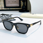 Chrome glasses with black frame and dark lenses, front view