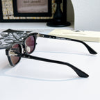 Chrome glasses with black frame and pink-tinted lenses, side view