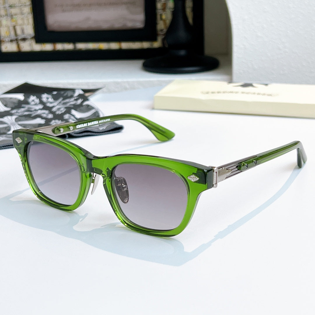 Chrome glasses with green frame and dark lenses, front view