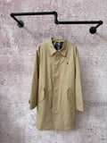 Tan long coat with buttoned front, notched collar, and two front pockets.