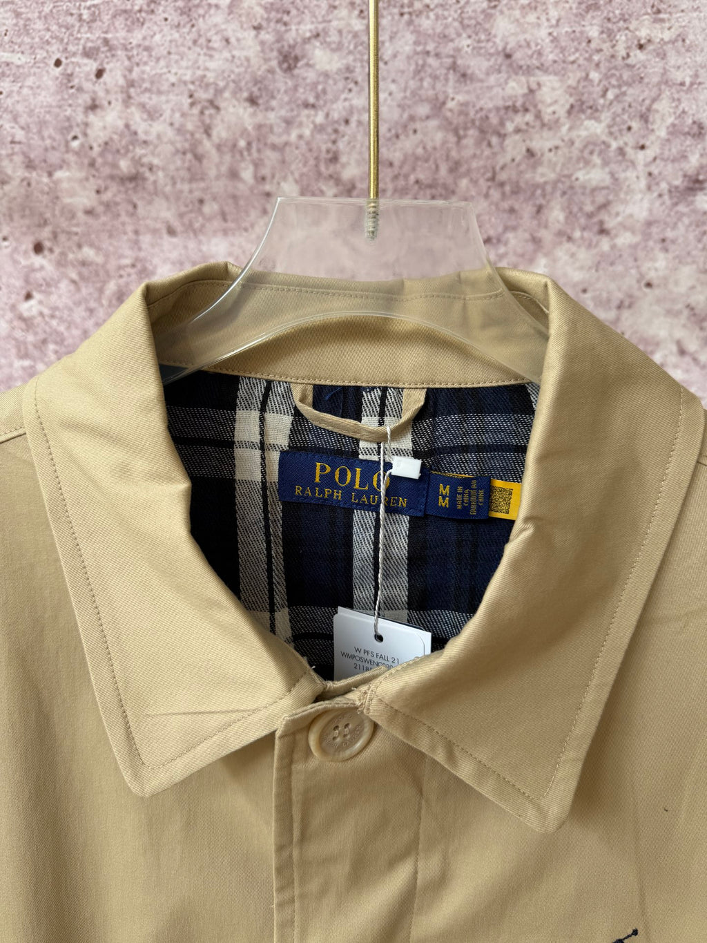 Tan coat collar with Polo Ralph Lauren neck label and plaid inner lining.