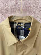 Tan coat collar with Polo Ralph Lauren neck label and plaid inner lining.