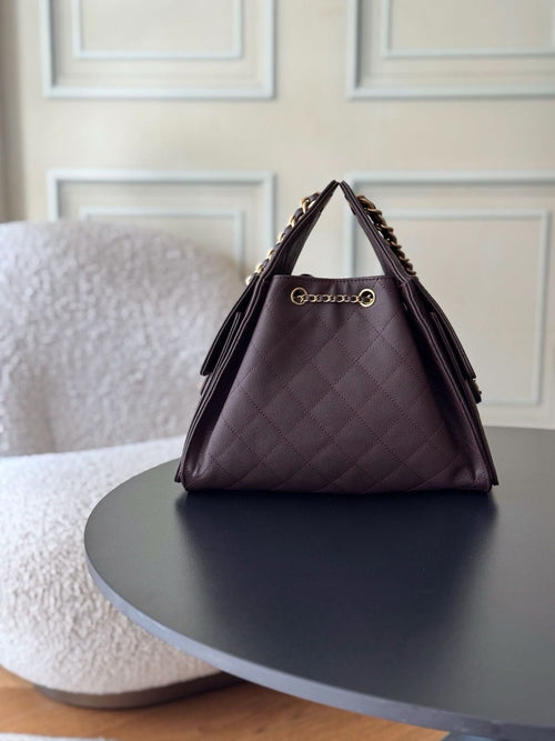 Chanel bag in dark plum quilted leather with gold chain strap and front logo clasp