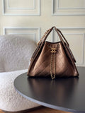 Brown quilted triangle shoulder bag with chain handle and logo clasp