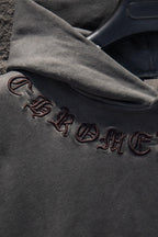 Embroidered text and symbols on dark gray hoodie sleeve cuff
