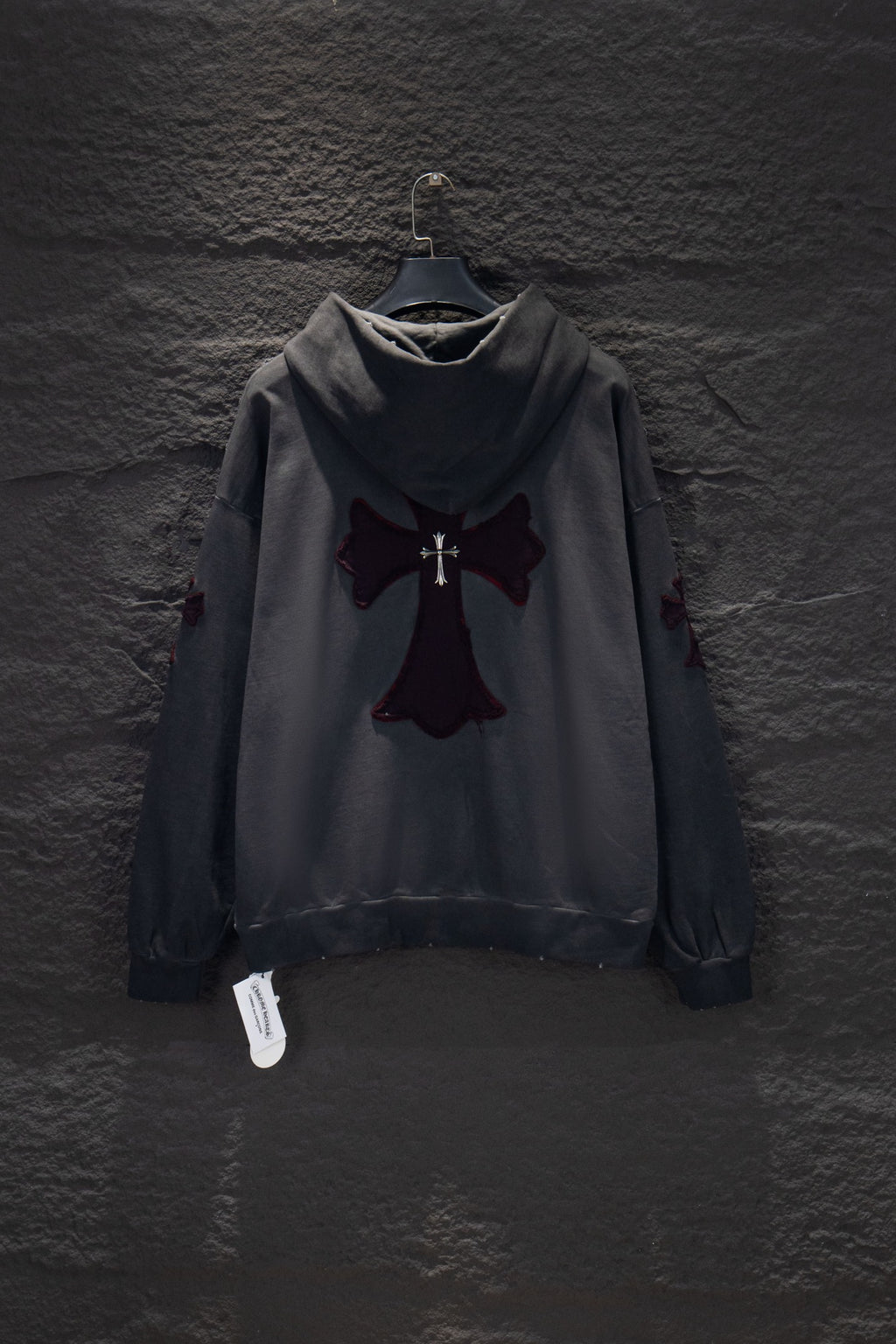 Dark gray long-sleeve hoodie with hood and cross emblem appliqué on chest