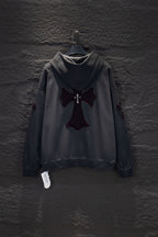 Dark gray long-sleeve hoodie with hood and cross emblem appliqué on chest