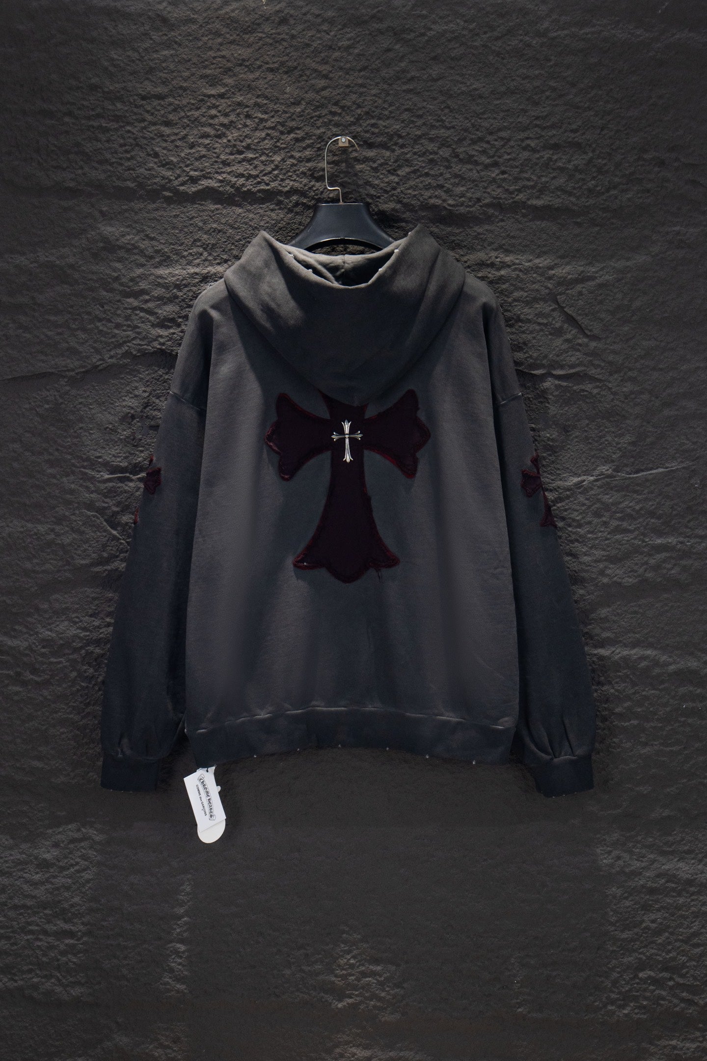 Dark gray long-sleeve hoodie with hood and cross emblem appliqué on chest