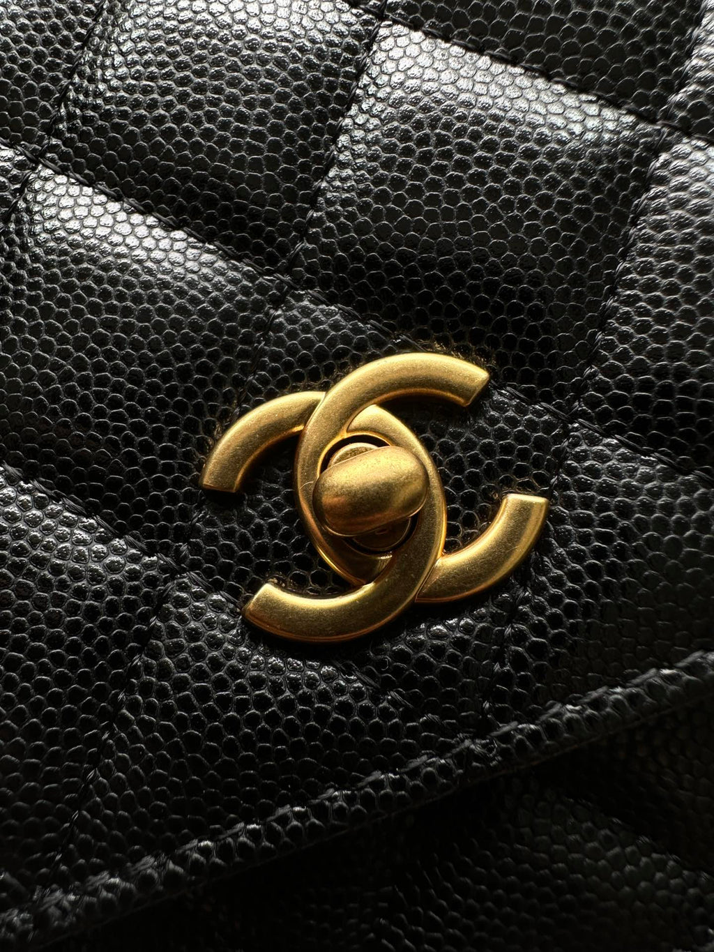 Chanel CC logo on black quilted leather flap bag, gold-tone hardware