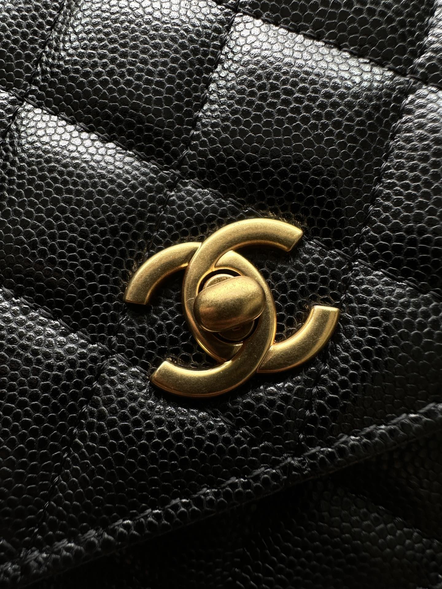 Chanel CC logo on black quilted leather flap bag, gold-tone hardware