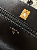 Black leather bag lining label with gold-tone Chanel and zipper track