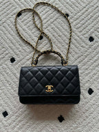 Quilted leather flap bag with gold-tone chain and Chanel CC clasp, black