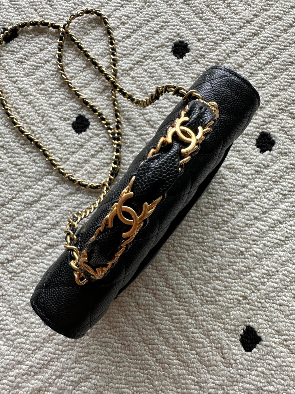 Black quilted leather bag with gold-tone chain strap and Chanel CC emblem