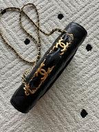 Black quilted leather bag with gold-tone chain strap and Chanel CC emblem
