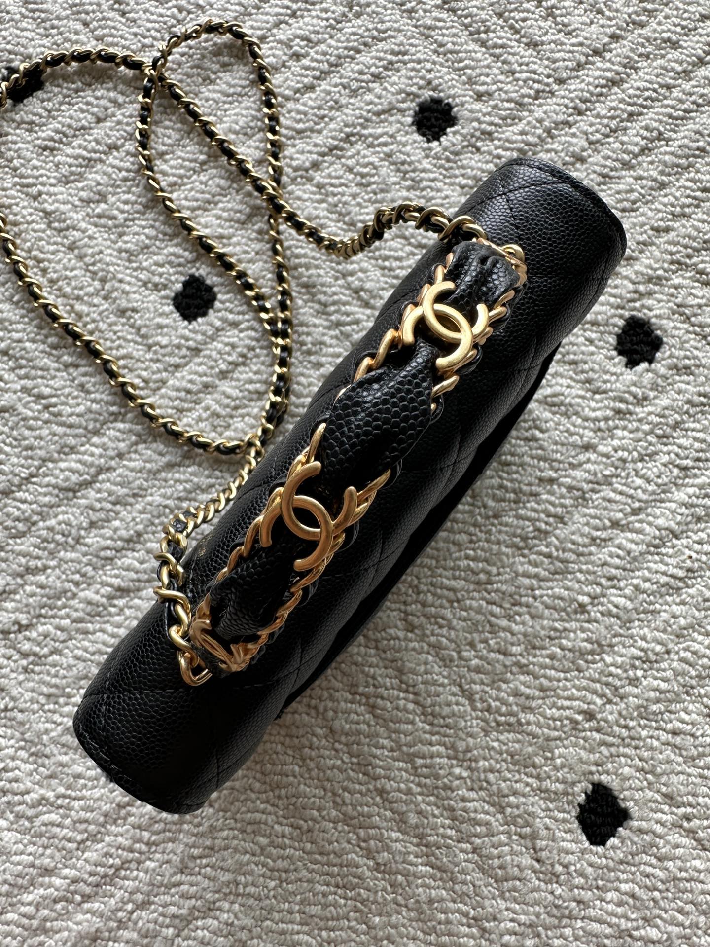 Black quilted leather bag with gold-tone chain strap and Chanel CC emblem