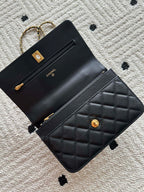 Quilted leather flap bag with gold-tone clasp and Chanel branding, black