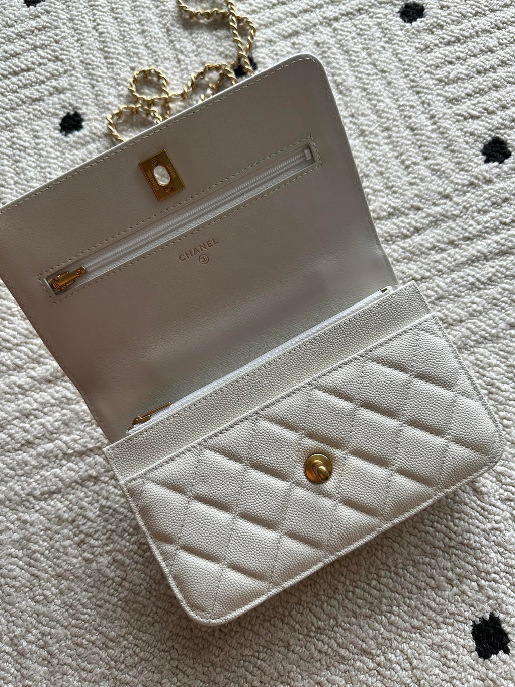 Chanel white quilted bag open view with front pocket and chain strap