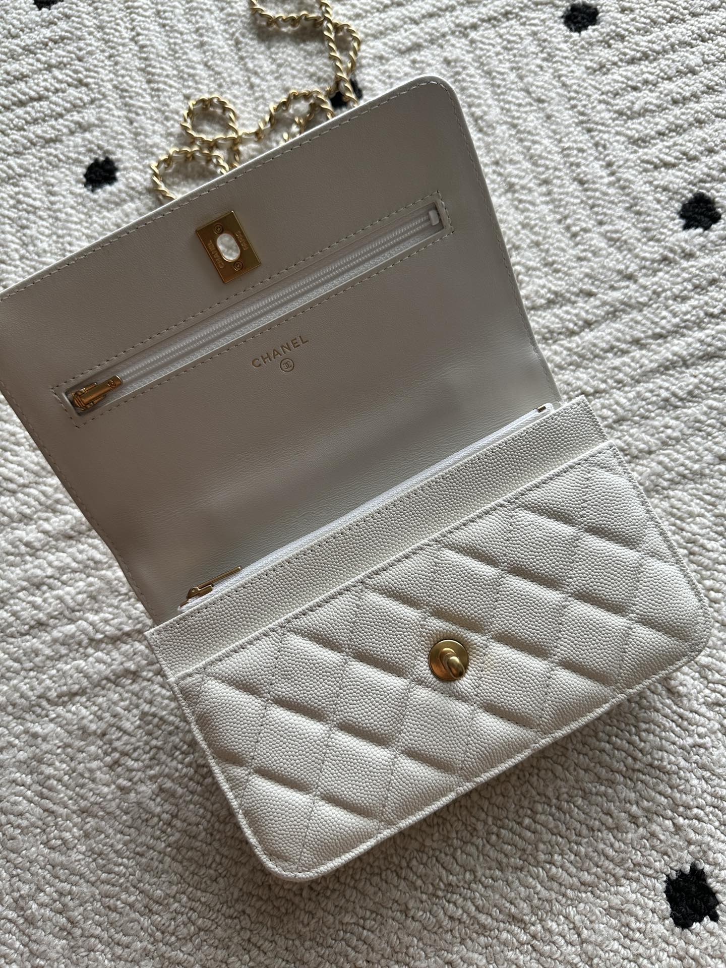 Chanel white quilted bag open view with front pocket and chain strap