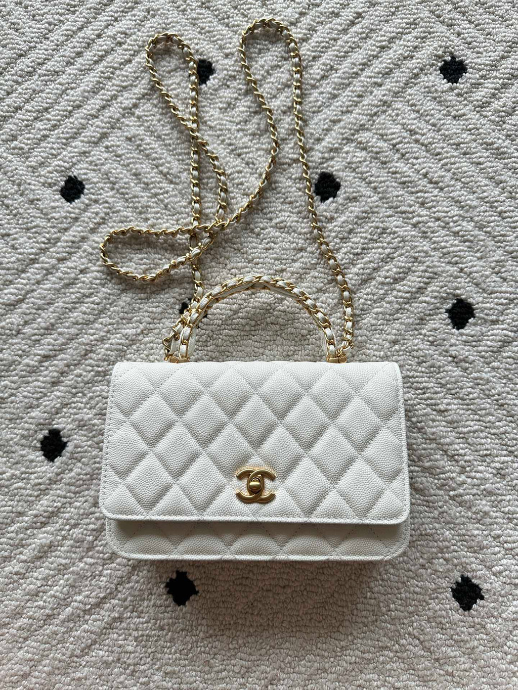 Chanel quilted white bag with gold CC logo and chain strap, flap closure