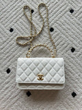 Chanel quilted white bag with gold CC logo and chain strap, flap closure
