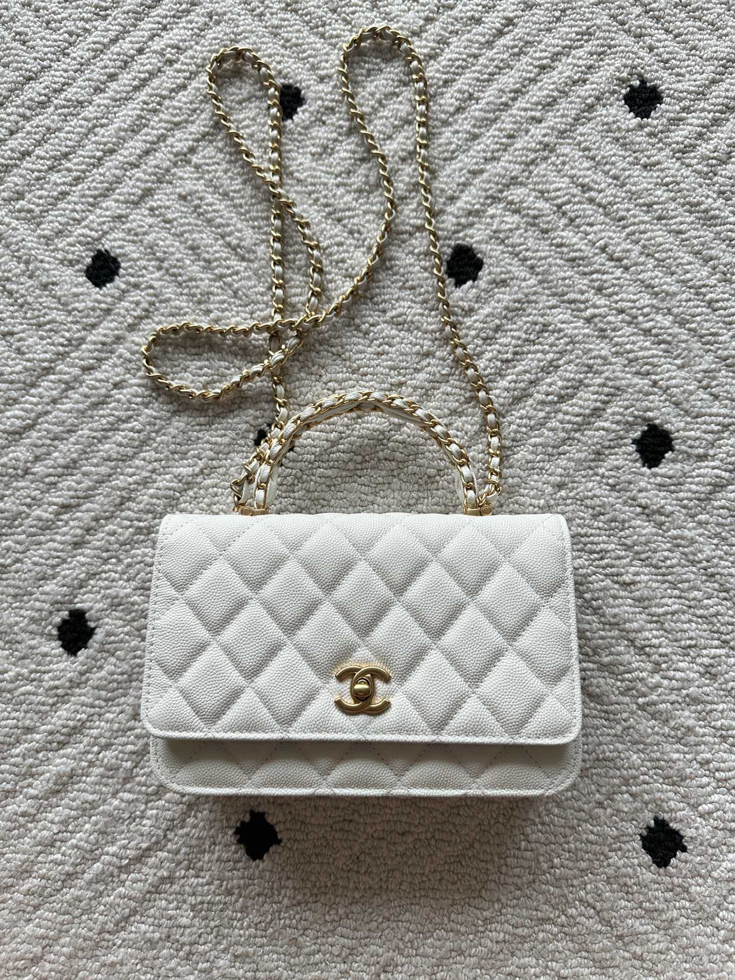 Chanel quilted white bag with gold CC logo and chain strap, flap closure