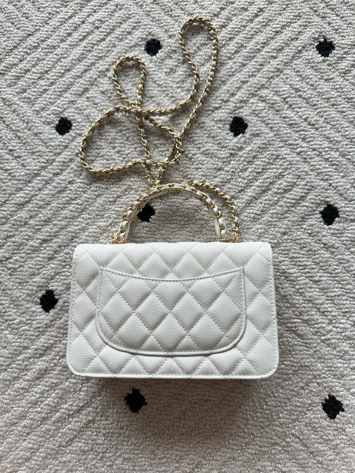 Chanel quilted white bag with chain strap and flap closure, single front panel