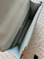 Chanel mini bag interior view with zip track and light blue lining