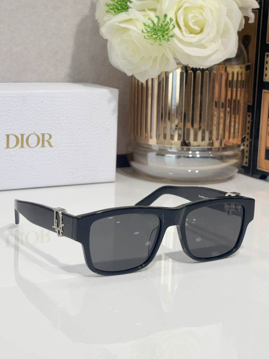 Dior sunglasses with dark frames and slightly rounded tinted lenses