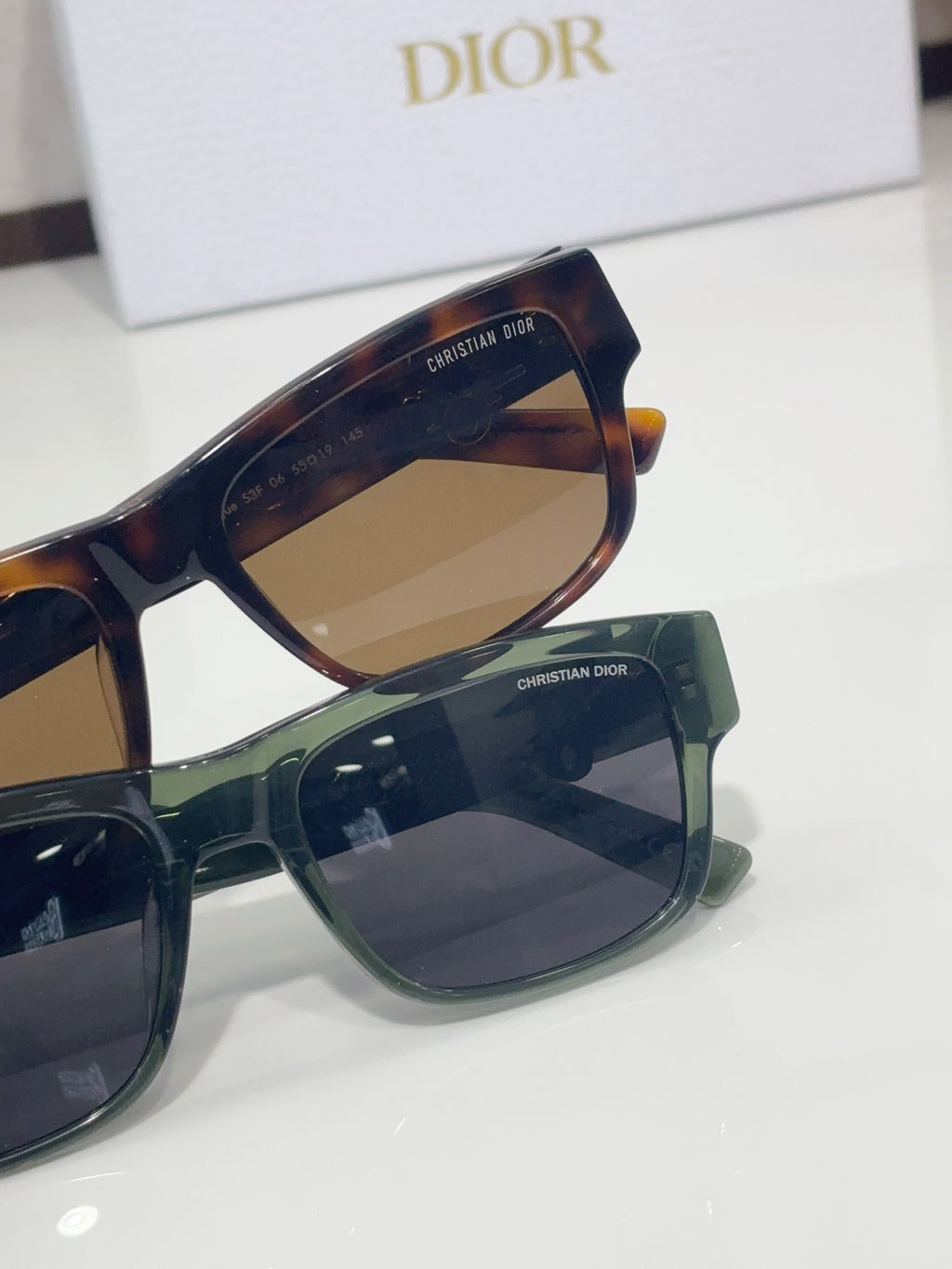 Dior sunglasses close-up with tortoiseshell frame and dark tinted lenses