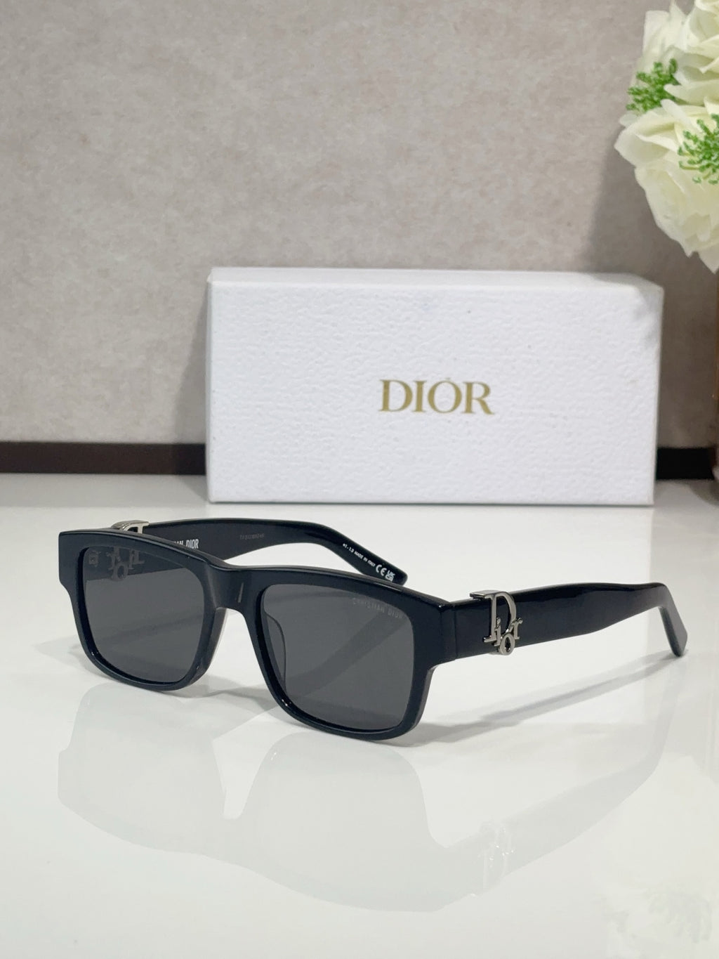 Dior sunglasses with navy frames and dark tinted lenses