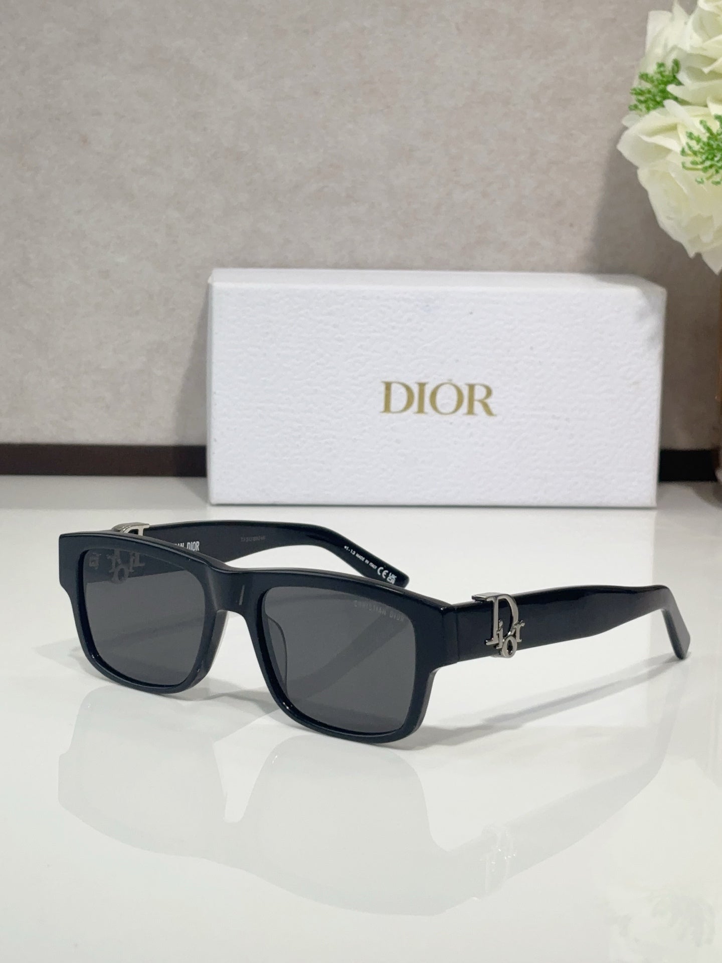 Dior sunglasses with navy frames and dark tinted lenses