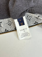 Long Louis Vuitton pants tag on gray fabric with yellow zipper and size label