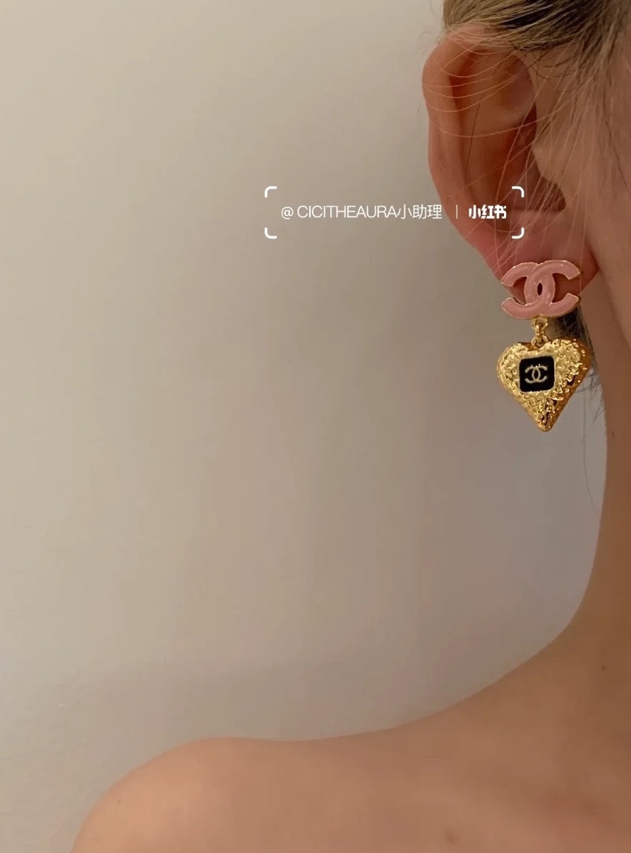 Gold-tone heart charm earring with pink CC hoop, worn