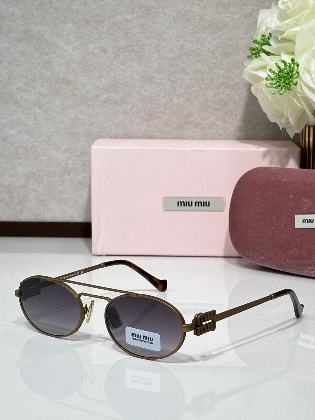 Gold metal round sunglasses with dark lenses and black temple tips