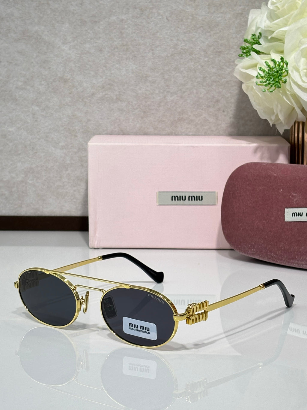 Gold metal round sunglasses with dark lenses and black temple tips