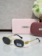 Gold metal round sunglasses with dark lenses and black temple tips