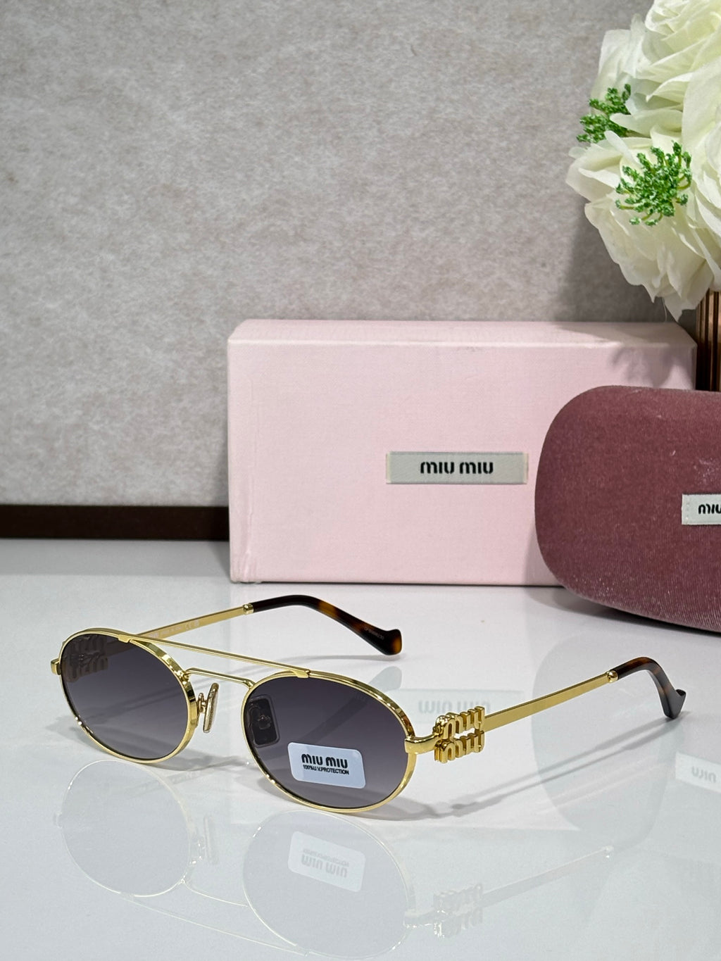 Gold metal round sunglasses with dark lenses and black temple tips