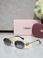 Gold metal round sunglasses with dark lenses and black temple tips
