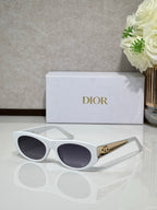 Dior sunglasses with white round frames, dark lenses, and gold logo bar on temple