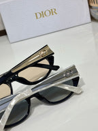 Dior sunglasses close-up with black frames and clear lenses, gold logo temple hardware