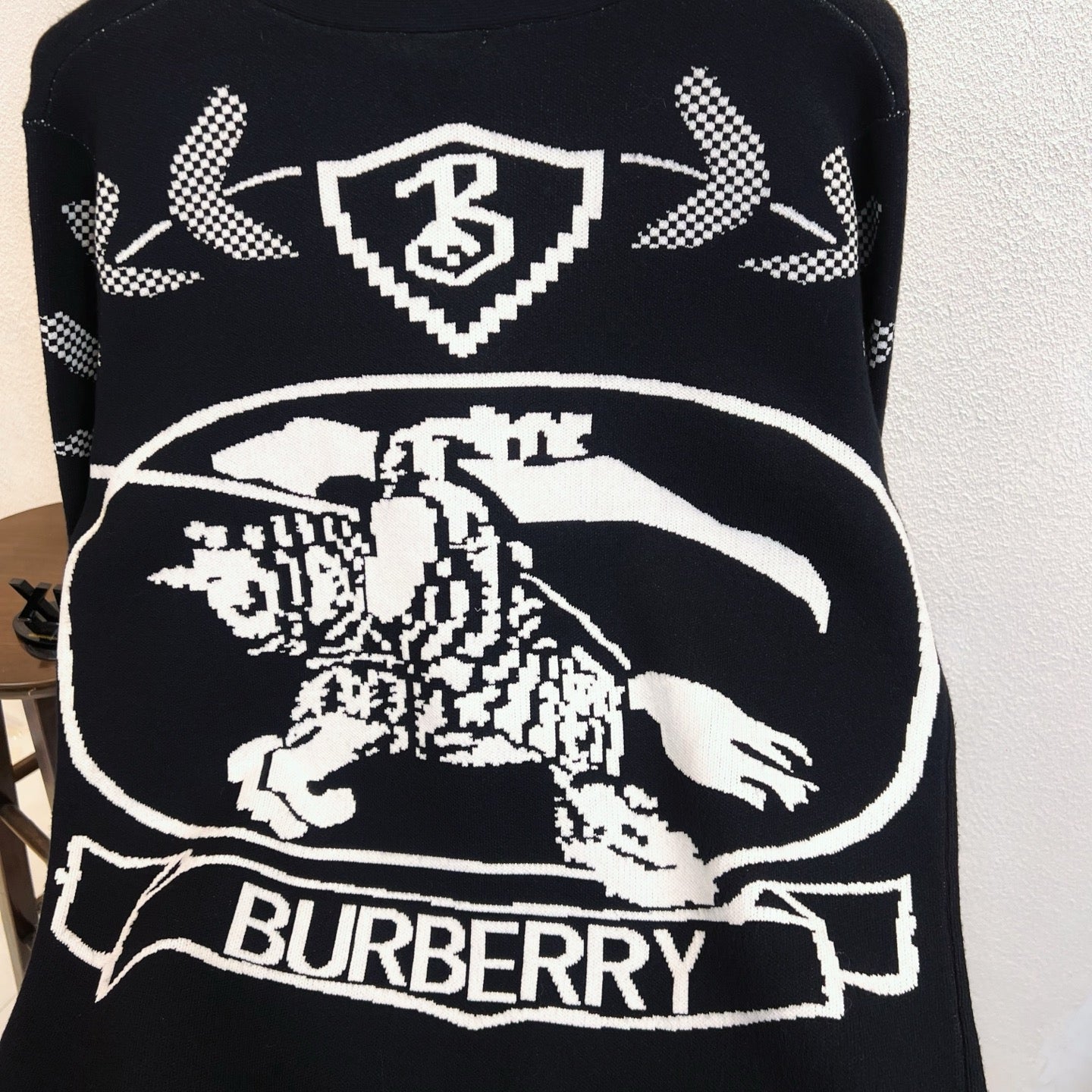 Black sweater with large Burberry horse graphic and check arrow motifs