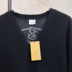 Black V-neck sweater top with Burberry label tag at neckline
