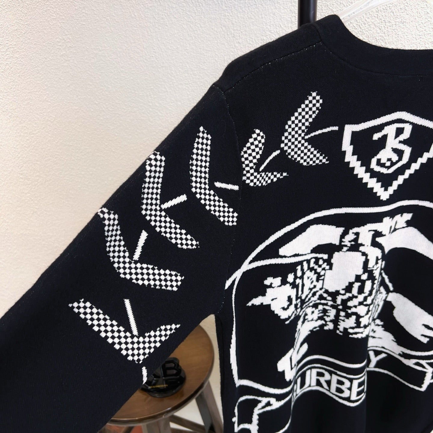 Black sweater with Burberry crest and horse graphic at side angle