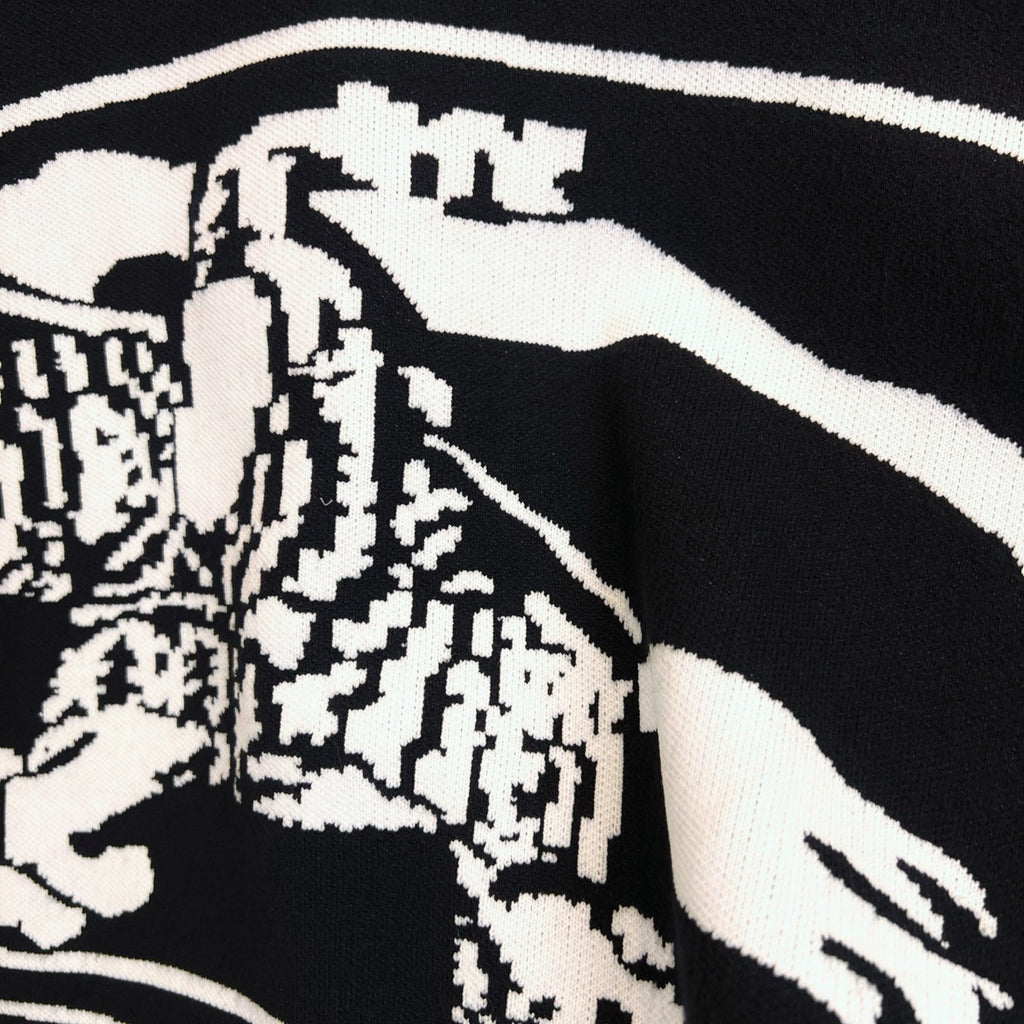 Black sweater with white-and-black patterned horse graphic detail