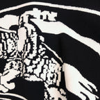 Black sweater with white-and-black patterned horse graphic detail