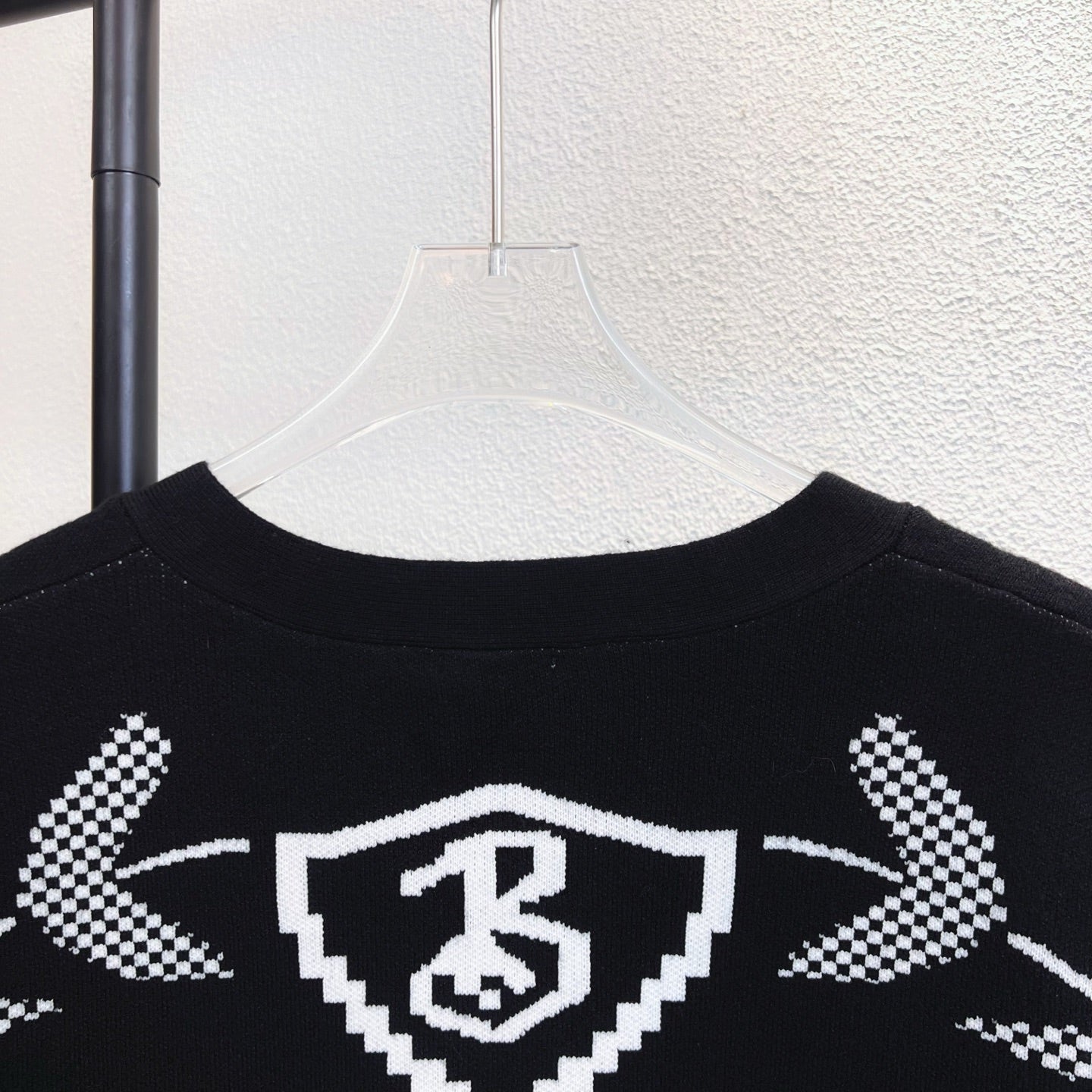 Black crew sweater with Burberry check crest graphic across upper back